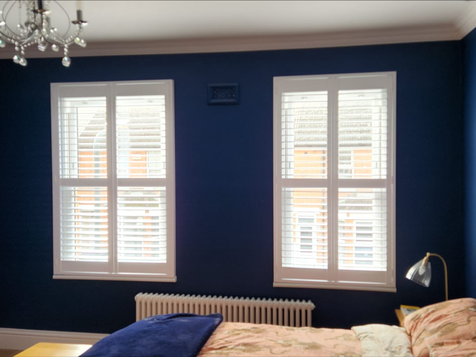 Pure white plantation shutters in a bedroom