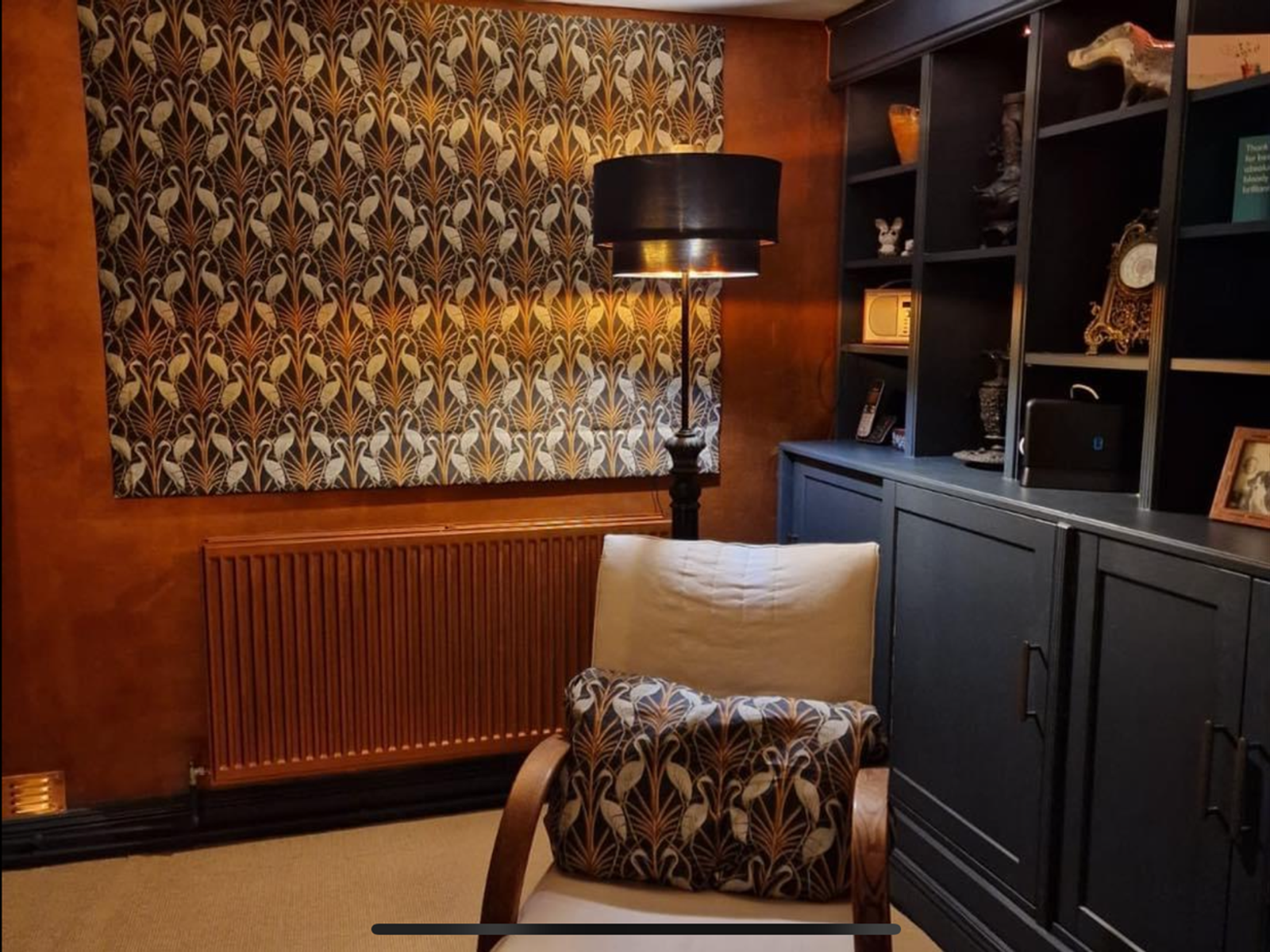 Roman blind in a living room with patterned wallpaper